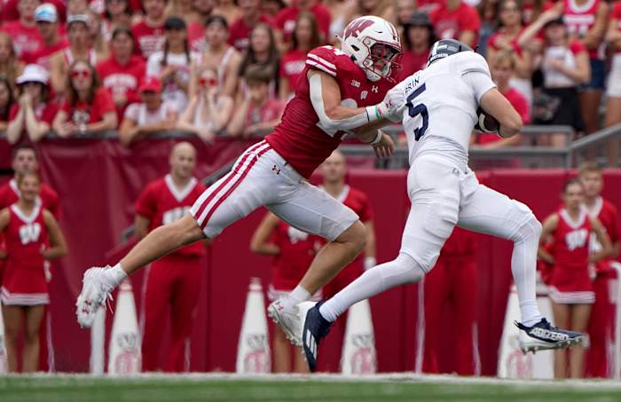 Sep 16, 2023; Madison, Wisconsin, USA; Wisconsin Badgers safety Hunter Wohler (24) sacks Georgia Southern Eagles quarterback Davis Brin (5) during the second quarter at Camp Randall Stadium. Mandatory Credit: Mark Hoffman-USA TODAY Sports